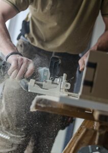 A photograph of a person using a saw.